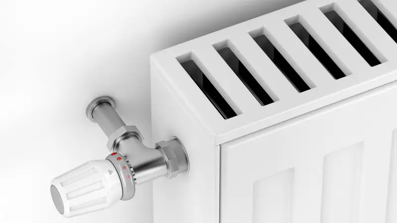 White heating radiator with thermostat valve installed by Bolton Domestic Gas Services Wolverhampton